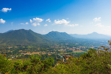 Fototapeta na wymiar Beautiful panoramic view green forest mountain range Phu Thok Park in Loei province,Thailand, blue sky background texture with white clouds