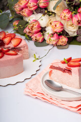 Strawberry cake on withe dish with berries and flowers on the table for Valentin's day or birthday party. High quality photo