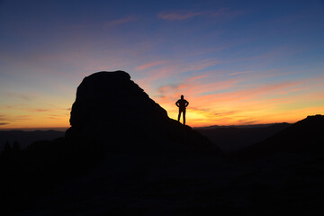 Contemplating sunrise in mountains-