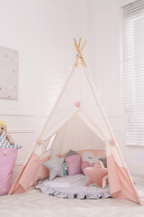 Cute child's room interior with toys, modern furniture and play tent © New Africa