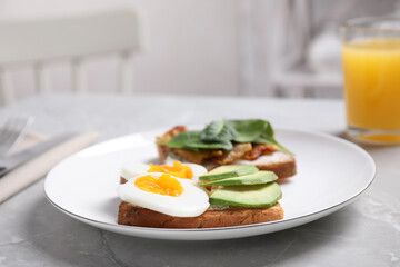 Delicious sandwiches served for breakfast on grey table, closeup