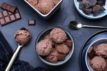 Yummy chocolate ice cream served on black table, flat lay