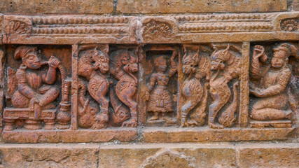 Detail of man with hookah and mythological creatures : intricate terracotta carving at Kantaji aka Kantajew medieval hindu temple in Kantanagar, Dinajpur, Bangladesh