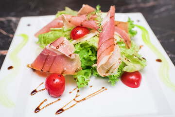 Fresh, tasty and healthy salad with melon and parma ham