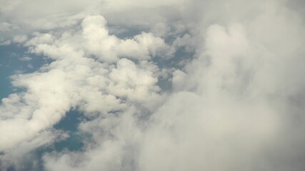Flying over the white clouds. The view from the airplane window.