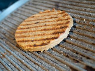 On a cooking plate a vegetable hamburgher mainly of soy