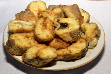 Pieces of fried fish on a plate close-up