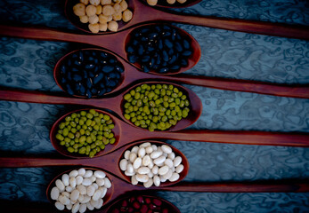 bean seed in wooden spoon, top view