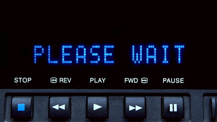 Disc player with screen. The word please wait is written on the screen.