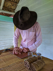 Vinales, Cuba - December 24, 2019: Man making luxury handmade cuban cigare.