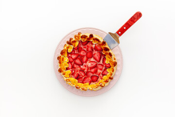 .Beautiful strawberry gift pie on a plate with a spatula
