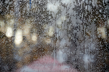 blurred background of grains and strips of frost on the glass