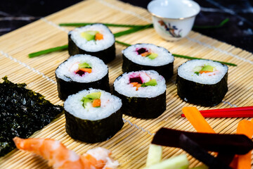 homemade sushi traditional japanese master making healthy maki rolls with prawns cucumber carrot fish