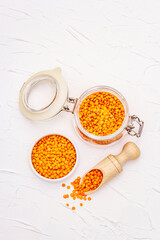 Dry orange lentils in glass jar