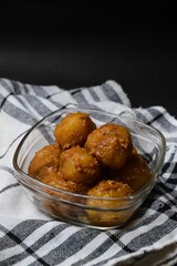 Cilok is balls prepared with a base of tapioca flour. Whether boiled or fried, cilok balls are typically accompanied by a sweet peanut sauce or spicy sauces based on ketchup and kecap manis. 