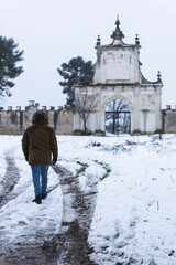 person on a road with snow and castle in the background