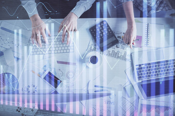 Double exposure of man and woman working together and financial chart hologram drawing. market analysis concept. Computer background. Top View.