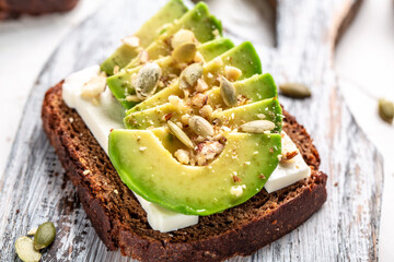 sandwich of rye bread with avocado and goat cheese for breakfast or lunch. Vegetarian food. Clean eating