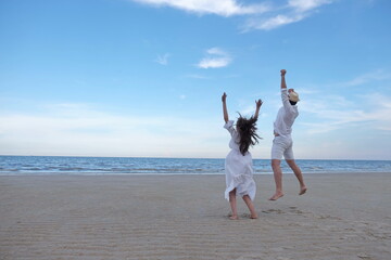 A romantic couple at the beach by the sea have white sand with the sound of waves and sunshine. With activities in the afternoon on a sweet holiday