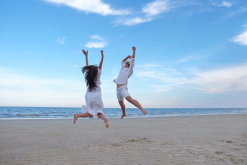 A romantic couple at the beach by the sea have white sand with the sound of waves and sunshine. With activities in the afternoon on a sweet holiday