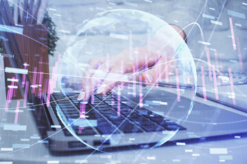 Multi exposure of woman hands typing on computer and forex chart hologram drawing. Stock market analysis concept.