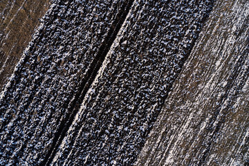 Texture of frozen plowed field from above, drone photography