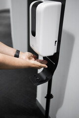 close up of a person using a dispenser