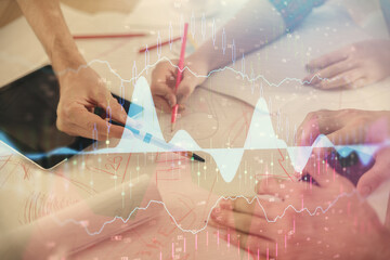 Double exposure of forex graph drawing and man and woman working together holding and using a mobile device. Trade concept.