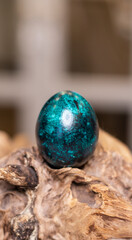 Dyed eggs in dark tidewater green tones. Easter festive background, open card, eggs close-up. Table setting for the Easter holiday. Christ is Risen Easter holiday.