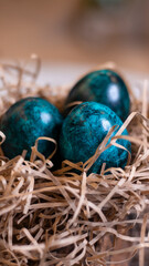 Dyed eggs in dark tidewater green tones. Easter festive background, open card, eggs close-up. Table setting for the Easter holiday. Christ is Risen Easter holiday.