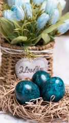 Obraz na płótnie Canvas Dyed eggs in dark tidewater green tones. Easter festive background, open card, eggs close-up. Table setting for the Easter holiday. Christ is Risen Easter holiday.