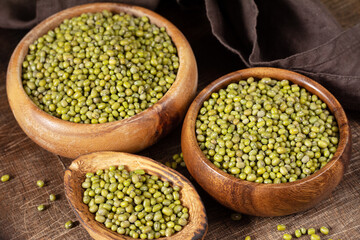Mung. Green mung beans in a bowl on a brown wooden table. Legume plant for a healthy diet	