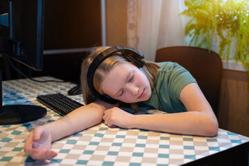 tired teenager lying and sleeping on table near computer, Gamer.