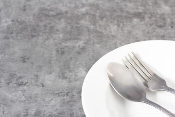 Closeup image practice forks or elegant silverware, blank on white plates for kitchen, dinner, party background with copy space for text.