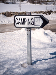 Camping sign in a winter snowy background.