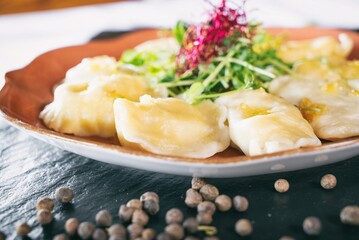 Dumplings with delicious meat on a plante. Dinner main dish on a wooden table. Traditional polish cuisine