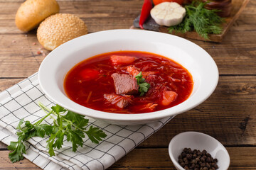  Traditional Ukrainian or Russian red borscht with sour cream in a white bowl. Beetroot soup.