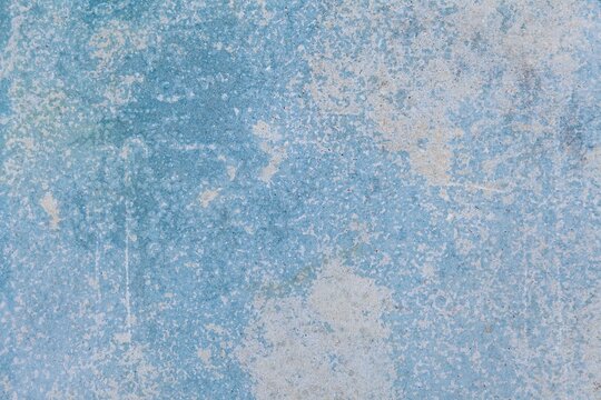 Old cement wall painted in light blue vintage texture and background