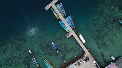 Fototapeta na wymiar Aerial view of top down picture of colorful wooden boats. Boats at the pier.