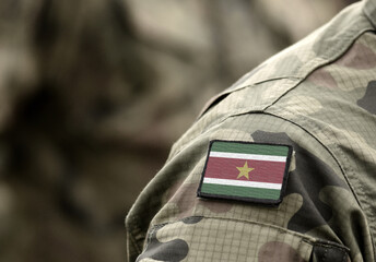Flag of Suriname on military uniform. Army, troops, soldier (collage).