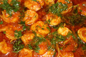 Spicy prawn curry garnished with coriander