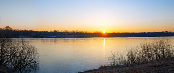 Beautiful landscape with old willow tree at sunrise. River