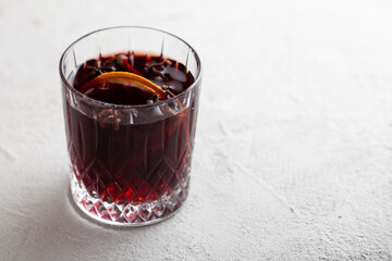 Aromatic mulled red wine on grey table.