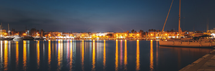 Fototapeta na wymiar The capital of the island of Kos, Greece, view of the city and marina at night, banner panoramic view