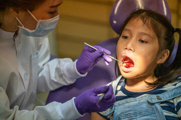 Asian dentist check up  little Asian girl teeth healthy in Dental's office. Dental care, Medical care, Lifestyle, Dental clinic or dental procedure concepts