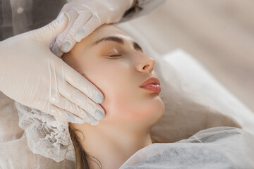 Cosmetoligist making face procedure. Face lifting massage. Skin care