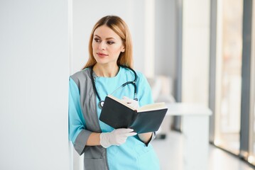 Beautiful smiling doctor woman in medical gown