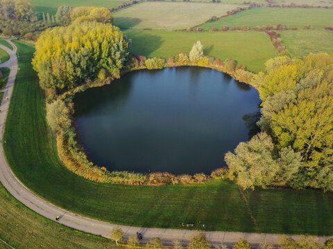 Aerial drone shot of the beautiful round-shaped small lake.