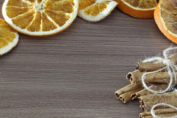 Dried orange and cinnamon sticks on the table. Place for text