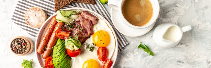 English breakfast. Fried egg, sausage, bacon, avocado, beans and toast on white background Top view, overhead, banner